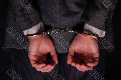 Arrested businessman handcuffed hands at the back