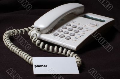 White business telephone on table.