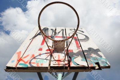 A basketball hoop with graffity.