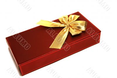 Dark red gift box with golden ribbon isolated on the white