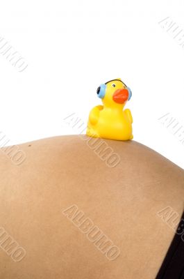 30 weeks pregnant teenager with music duck on her belly