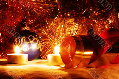 The burning candles, balls and gold ribbons it are Christmas