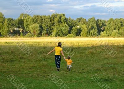 Mother with child on the sunset