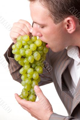 man eats green grapes