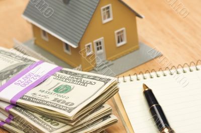 House and Money with Pad and Pen