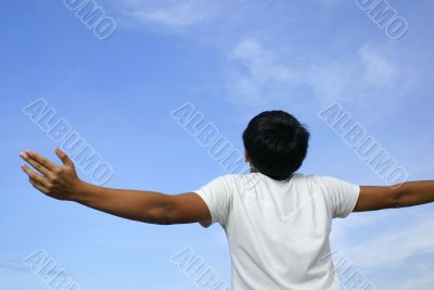 Happy man spread arms to sky