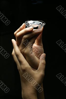 Female hands holding diamond