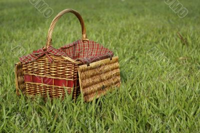 Picnic hamper basket in field