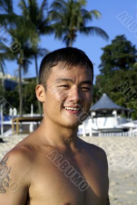 Fit asian man at beach