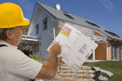 Construction worker with plan of an architect