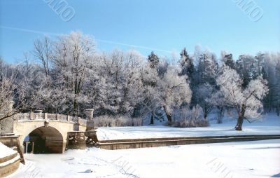 Winter river with old bridge