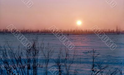 Skiers in winter sunset