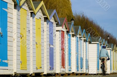 Beach hut and cyclist