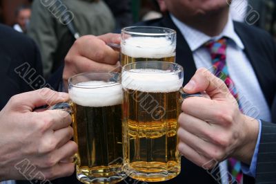 business men toasting with their beers