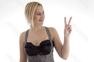 smiling woman making peace sign