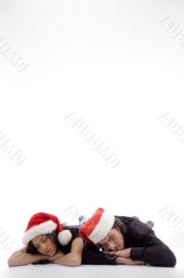 two friends lying on the floor with christmas hat