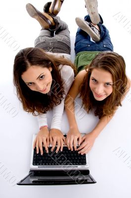 cute teenager girls busy on laptop