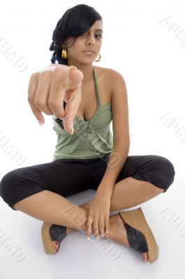 teenager girl pointing towards camera