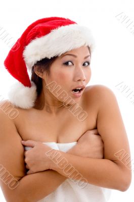 young woman in towel wearing christmas hat