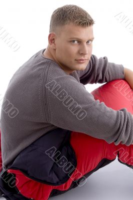 young caucasian man sitting in the sleeping bag