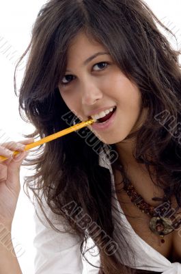 young female with pencil in her mouth