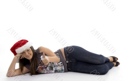 young woman in christmas hat lying on floor