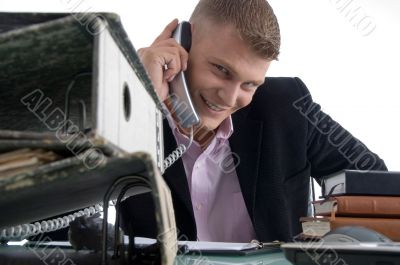 handsome smiling manager busy on phone