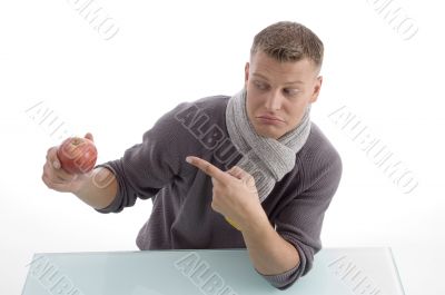 young male pointing the apple
