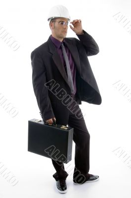 male architect in helmet holding office bag