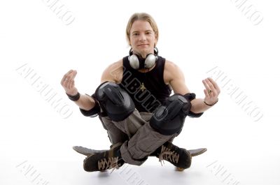 young man sitting on skateboard