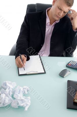 businessman writing on paper pad