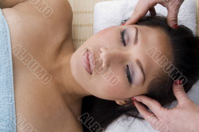young woman taking head massage