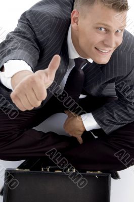 handsome young businessman with thumbs up
