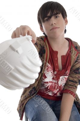 smiling young architect showing his helmet