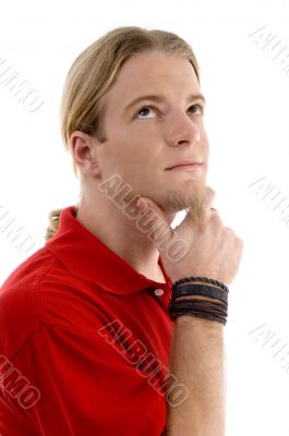 smart young man thinking and looking sideways