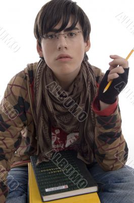 student with pencil and books
