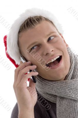 smiling male with christmas hat talking on phone