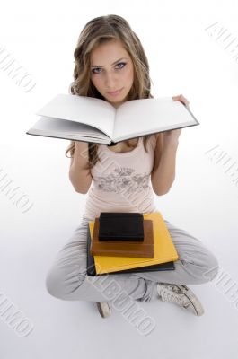 sitting student showing the book