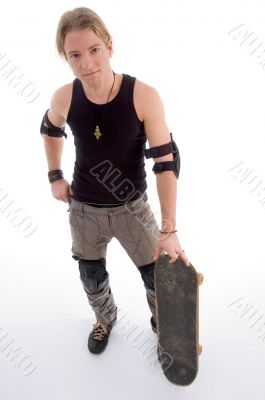 handsome guy standing with skateboard
