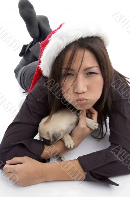laying woman with christmas hat and pug