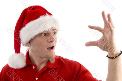 christmas hat wearing male looking at palm