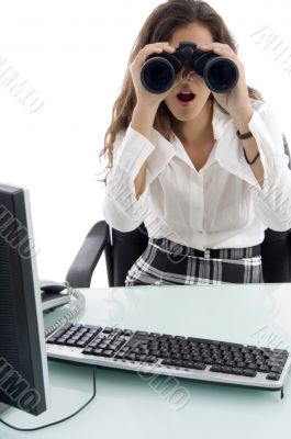 woman in office and looking through binocular