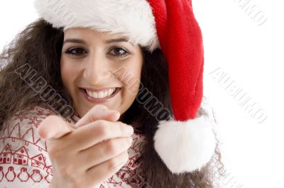 young female with christmas hat pointing at camera
