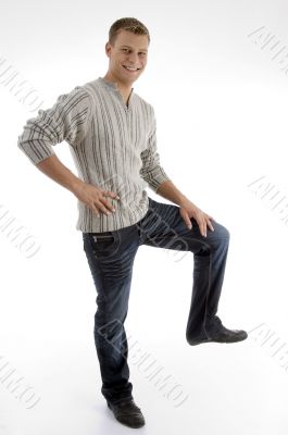 smiling man standing on one leg