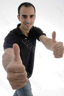 handsome young man posing with his thumbs up
