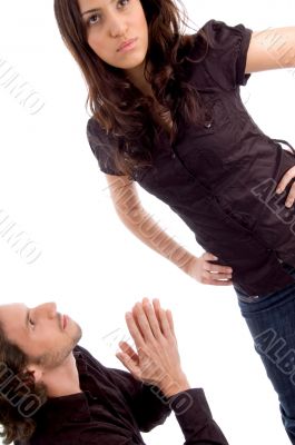 man begging in front of woman