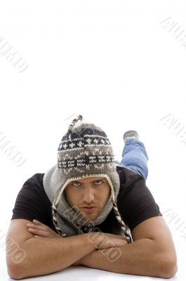 young male lying and wearing woolen cap