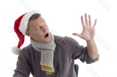 smiling young man with christmas hat showing