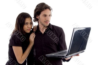 young couple looking into laptop
