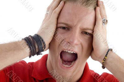 male holding his head and shouting